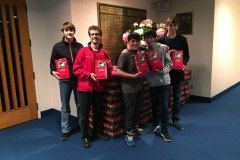 Image of Altar Servers with Christmas packages in the Church foyer.