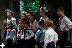 Image of St. Demetrius Church's Youth Choir singing Ukrainian folk songs at the performance showcase.