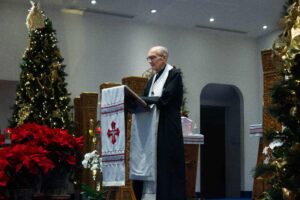 Image of Father John preaching a sermon during the Christmas Eve service (Christmas Eve 2023).